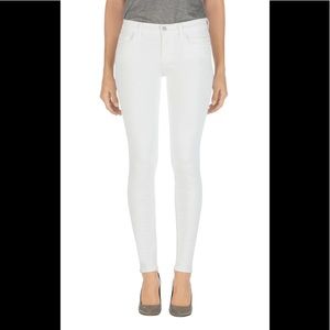 J Brand 811 Mid Rise Skinny Jeans in Blanc